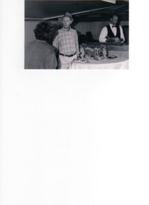 Photograph of a man in a hat at the bar being served by the barman